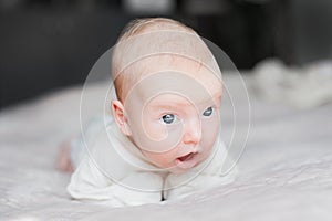 Cute baby on the white bed