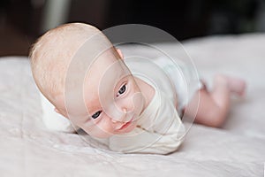 Cute baby on the white bed