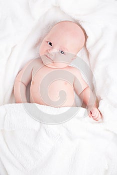 Cute baby wrapped into towels