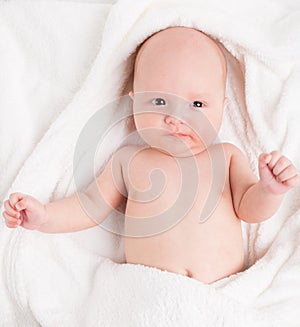 Cute baby wrapped into towels