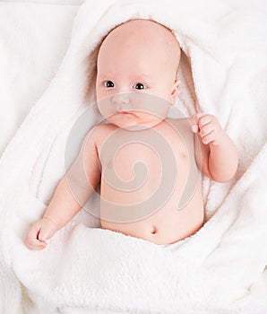 Cute baby wrapped into towels