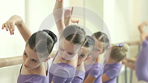 Cute ballerinas having practice at ballet hall.