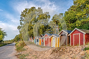 Cute beach huts in a row in the sand