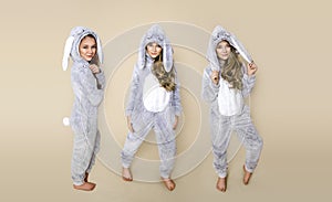 Cute, beautiful blonde young girl dressed in pajamas kigurumi with rabbit ears.