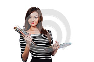 Cute beautiful girl artist holding a palette and brush in the process draws inspiration. White background, isolated.