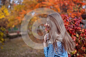 Cute beautiful smile woman walking in red autumn park