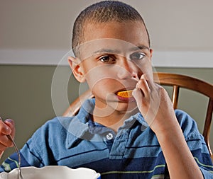 Cute Bi-Racial Boy Eating Orange