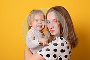 Cute big sister admiring her baby sister. Adorable teen girl holding her new baby girl sister. Kids with large age gap.