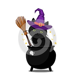 A cute black kitten in a purple witch hat sits in a cauldron next to a witch`s broom