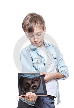 Cute blond boy in a blue shirt holding a brown tablet pc