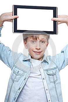 Cute blond boy in a blue shirt holding a tablet pc with white screen