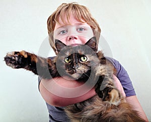 Cute blond boy with a cat