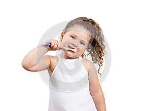 Cute blond girl brushing her teeth on isolated white background.