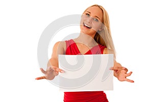 Cute blond woman with blank white banner in her hands smiling is