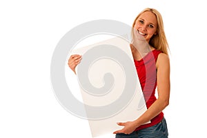 Cute blond woman with blank white banner in her hands smiling is