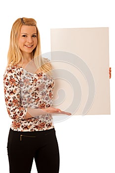 Cute blond woman with blank white banner isolated over white background