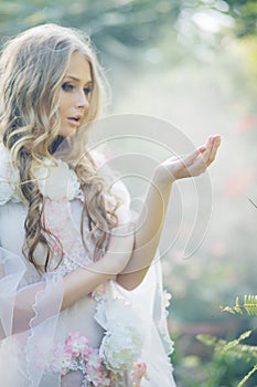 Cute blond woman in the tropical garden