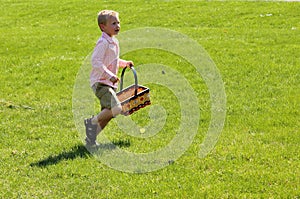 Cute blonde boy on an easter egg hunt