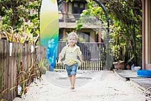 Cute blonde boy walking barefoot