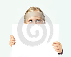 Cute blonde child girl holding white empty blank banner board with copy space on white background