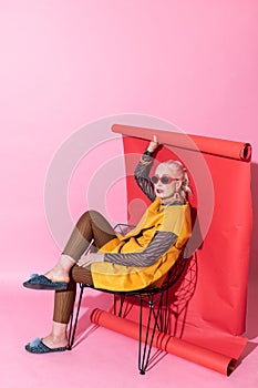 Cute blonde female sitting on cozy chair