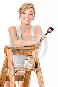 Cute blonde girl, in overalls, resting on old ladder