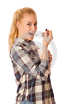 Cute blonde woman eating fruit yogurt isolated over white background photo