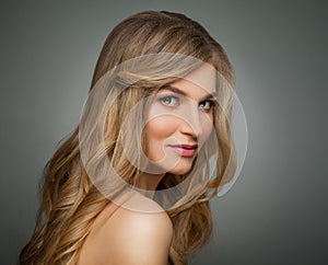 Cute blonde woman with long healthy hair and clear skin portrait