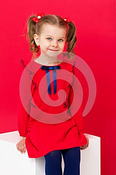 Cute blue eyed girl staring at camera in studio