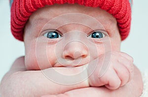 Cute blue-eyed infant with wide eyes otkoytymi