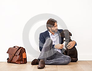Cute, bonding and happy businessman with dog by wall with positive attitude together. Career, briefcase and professional