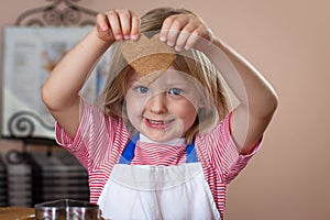 Cute boy baking ginger bread cookies