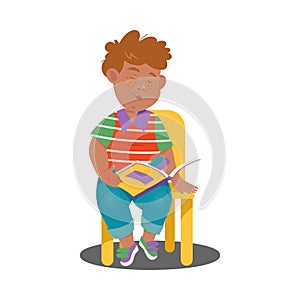 Cute Boy Character Sitting on Chair with Open Book and Reading Vector Illustration