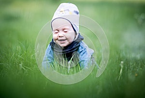 Cute boy in spring grass