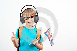 Cute boy demonstrating United Kingdom flag. Smiling student with backpack and uk flag. Foreign language school