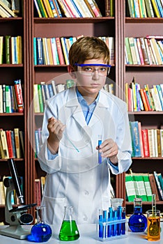 Cute boy doing biochemistry research in chemistry