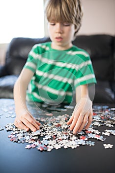 Cute boy doing a puzzle