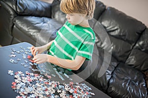 Cute boy doing a puzzle