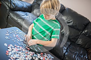 Cute boy doing a puzzle