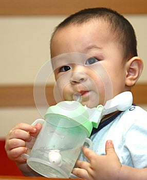 Cute boy drinking