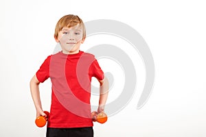 Schoolboy training with dumbbells, isolated on white. Physical training for kids. Healthy childhood. Fitnesss for children. Copy photo