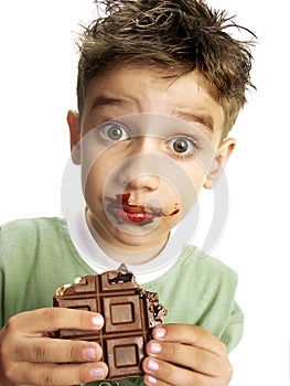 Cute boy eating chocolate