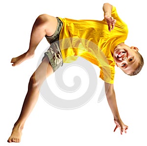 Cute boy exercising, dancing and jumping over white