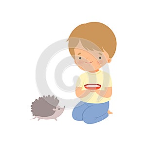 Cute Boy Feeding Hedgehog with Milk, Kid Interacting with Animal in Contact Zoo Cartoon Vector Illustration