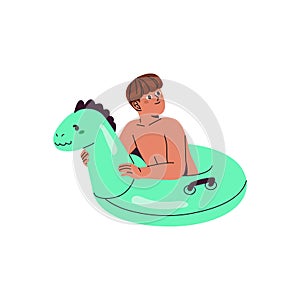 Cute boy floating on inflatable circle. Funny kid playing in water with lifebuoy. Child on inner tube in swimming pool