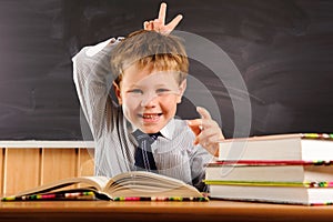 Cute boy fooling at the lesson photo