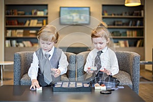 Cute boy with girl in business clothes play with