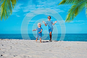 Cute boy and girl dance at beach, kids enjoy vacation at sea