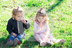 Cute boy and girl on spring field. Outdoor kids activities. Family spring holidays with children. Happy children playing