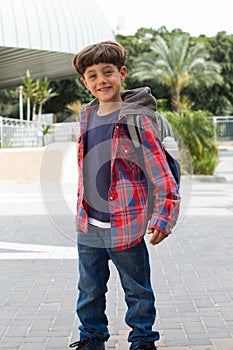 Cute boy going to school with backpack